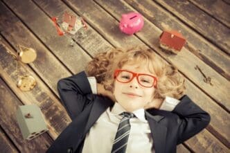 A young businessman in a modern loft office smiles, embodying success and creativity.