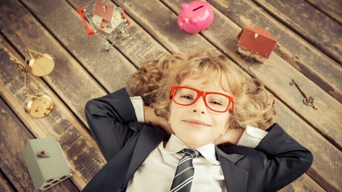 A young businessman in a modern loft office smiles, embodying success and creativity.