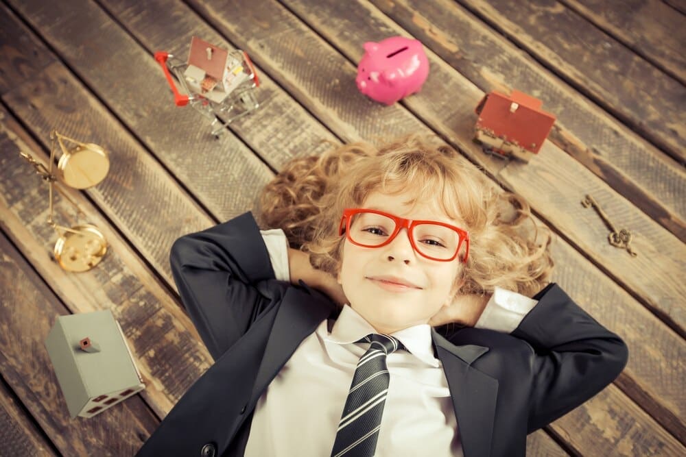 A young businessman in a modern loft office smiles, embodying success and creativity.