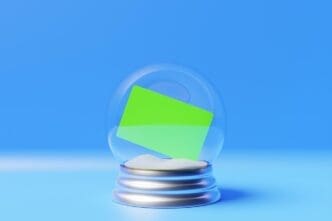 A realistic, transparent glass sphere rests on a podium, with a white sheet nearby, all against a light background.