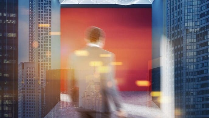 Rear view of a businessman walking down an empty hall with red walls and a geometric ceiling, overlaid with a toned double exposure effect.