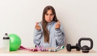 A person holds up empty pockets, demonstrating a lack of money.