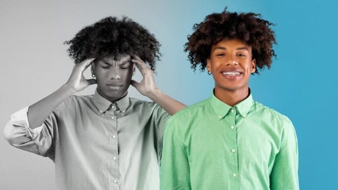A Black millennial man with a pained expression covers his ears, likely experiencing a headache or distress.