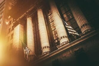 The New York Stock Exchange building features the American flag waving in front of its neoclassical facade.