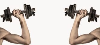A thin man in athletic wear lifts a dumbbell, showcasing his bicep muscle.