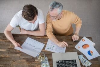 Two men collaborate intently on a project.