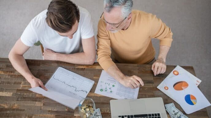Two men collaborate intently on a project.