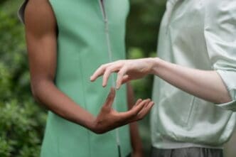 Two young men of different ethnicities smile and pose together for a social campaign.