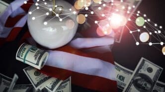 A red apple sits on a table covered with US dollar banknotes, representing business in New York City.