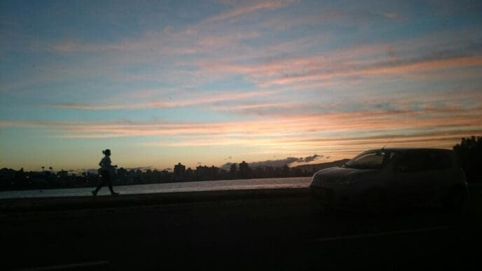 Vibrant colors of orange and purple fill the sky during a sunset.