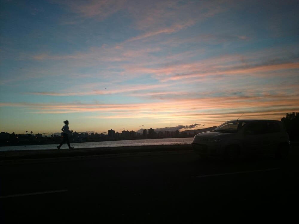 Vibrant colors of orange and purple fill the sky during a sunset.
