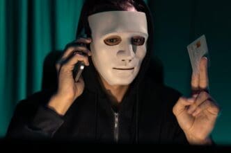 White criminal mask, with a menacing expression, used in a phishing scam to demand a credit card owner's financial information.