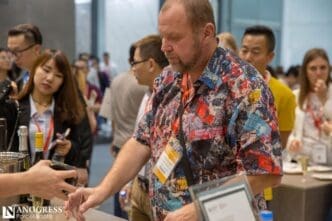 People are gathered at a wine tasting event, sampling wine.