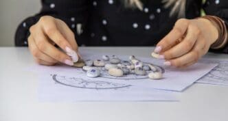 A woman, likely a numerologist or astrologer, is counting numbers, with a selective focus on her hands.
