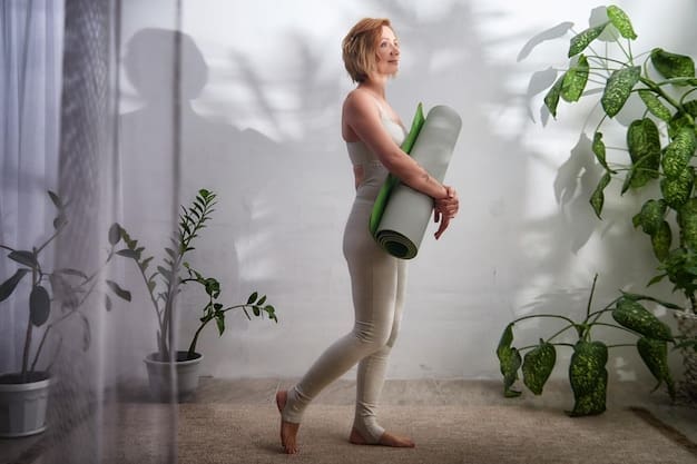 A woman practices yoga on a mat indoors, embodying a healthy lifestyle in a peaceful setting.