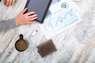 A woman's hand rests on a table.