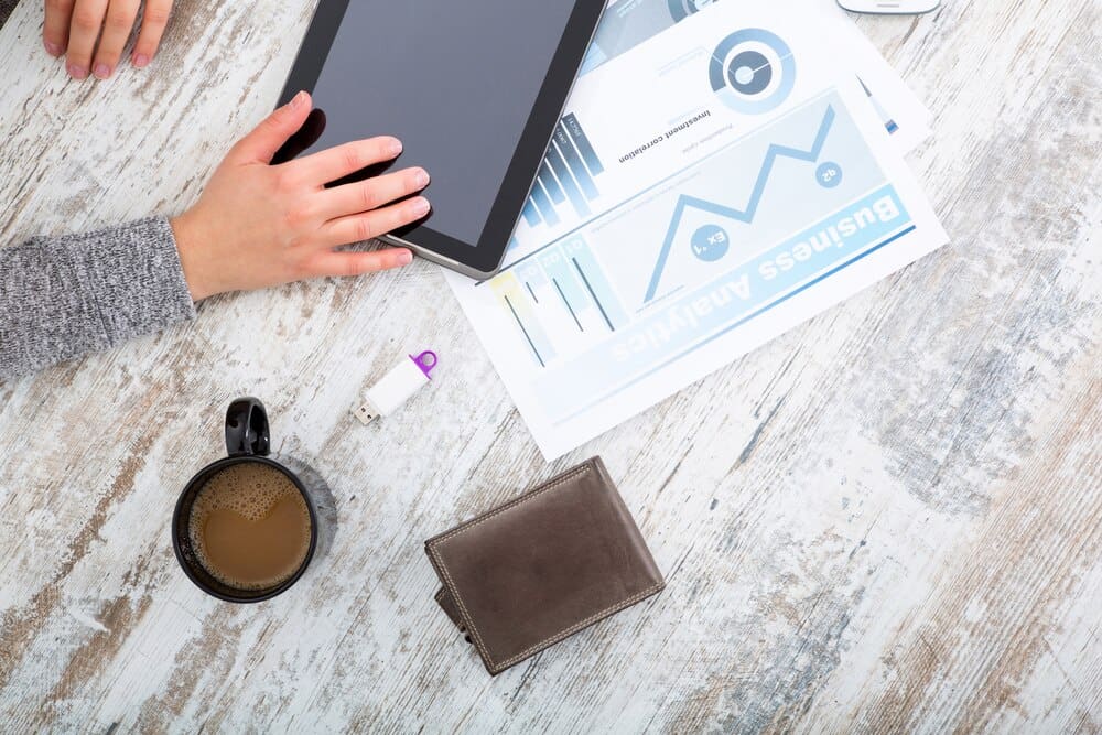 A woman's hand rests on a table.