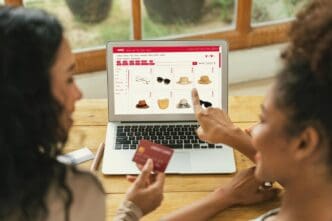 Woman using a credit card to make an online purchase on a modern lifestyle website, with a focus on cybersecurity.