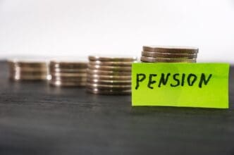 Sticker with the word "pension" next to stacks of coins.
