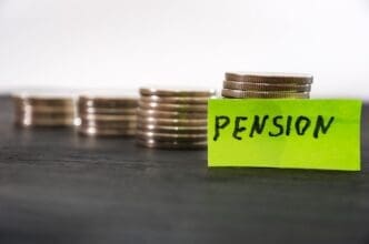 Sticker with the word "pension" next to stacks of coins.