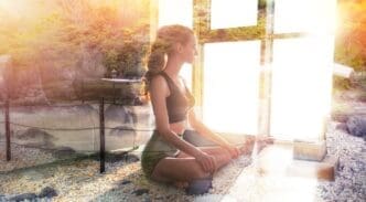 A young girl in a yoga pose is superimposed over a tranquil zen garden.