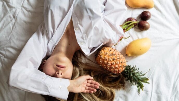 A young woman is lying on a bed.