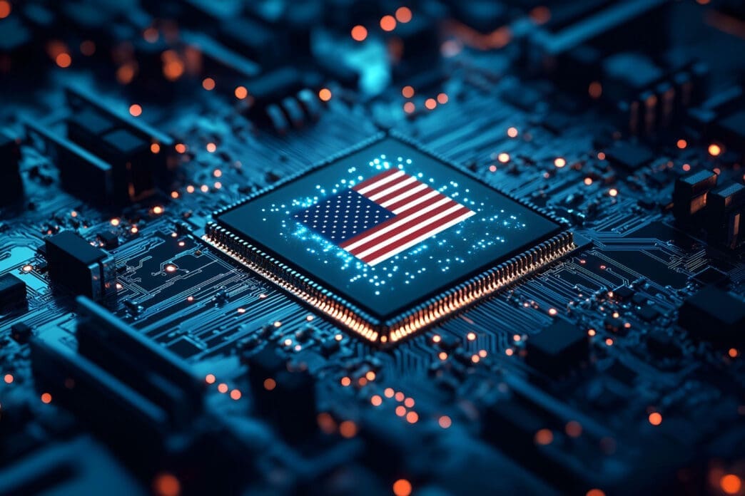 A close-up view of a microchip with the American flag on its surface, placed on a futuristic-looking circuit board.