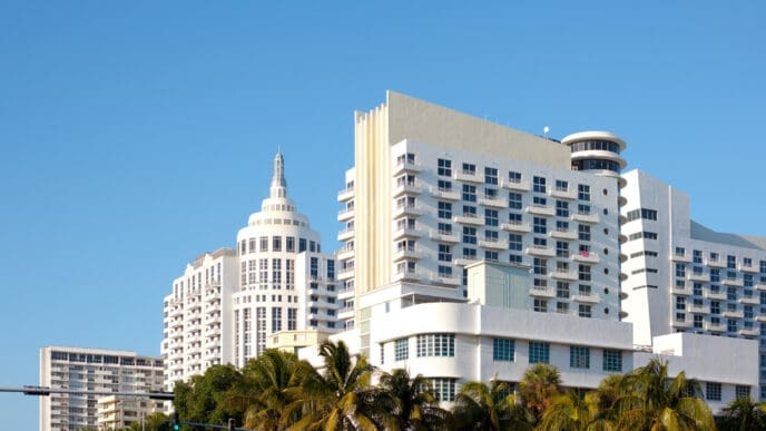 The Art Deco style buildings of Miami Beach stand against a clear blue sky.