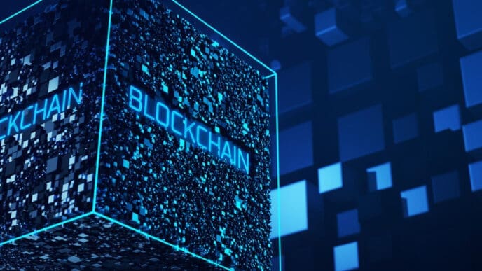 A conceptual 3D render of a large, glowing blue cube made up of smaller blocks, with the word "BLOCKCHAIN" written on its sides.