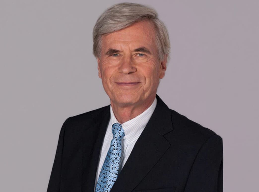 A professional portrait of German billionaire Dieter Schwarz, smiling and wearing a suit and tie.