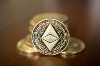 A close-up, low-angle shot of a gold Ethereum Classic cryptocurrency coin