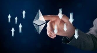 A man's hand is tapping a glowing wireframe Ethereum symbol, with arrows pointing both up and down around it.