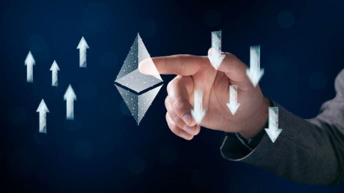 A man's hand is tapping a glowing wireframe Ethereum symbol, with arrows pointing both up and down around it.