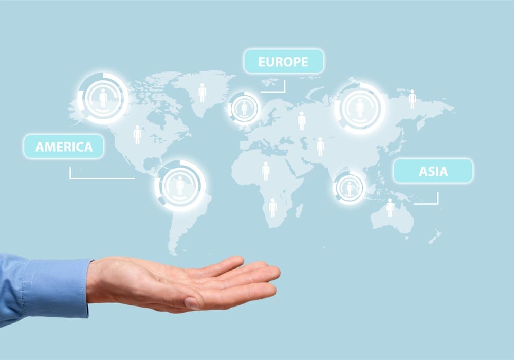 A hand holds up a glowing world map with labels for America, Europe, and Asia, and icons representing people on each continent.