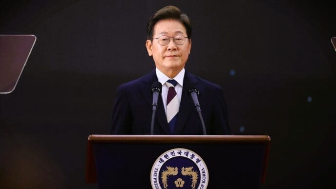 Lee Jae-myung speaks from a podium with the official presidential seal in front of him