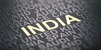 The word "INDIA" is highlighted in yellow on a gray background among a crowd of other country names