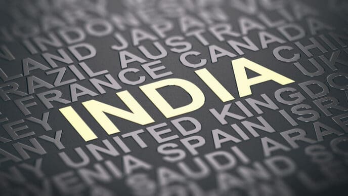 The word "INDIA" is highlighted in yellow on a gray background among a crowd of other country names