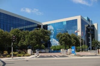 The Intel headquarters building in Santa Clara, California, featuring a large temporary poster of co-founder Gordon Moore on its facade.