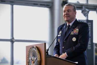 Lieutenant General Jeffrey A. Kruse in uniform stands at a podium with the Department of Defense seal.