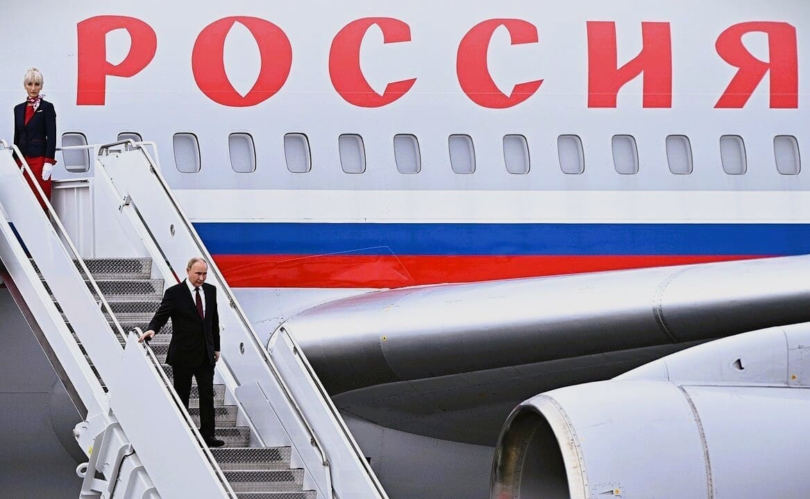 Russian President Vladimir Putin disembarks from his airplane, walking down the stairs in Anchorage, Alaska.
