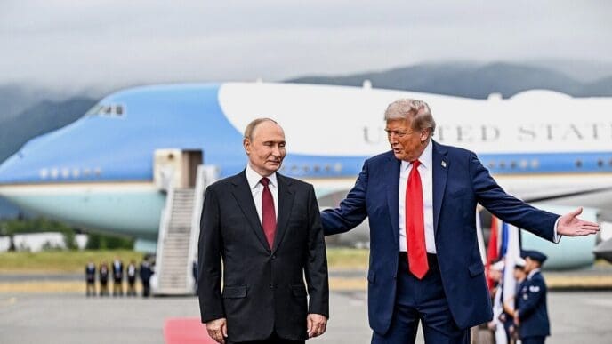 U.S. President Trump and Russian President Putin stand on an airport tarmac in Anchorage, with Air Force One in the background.