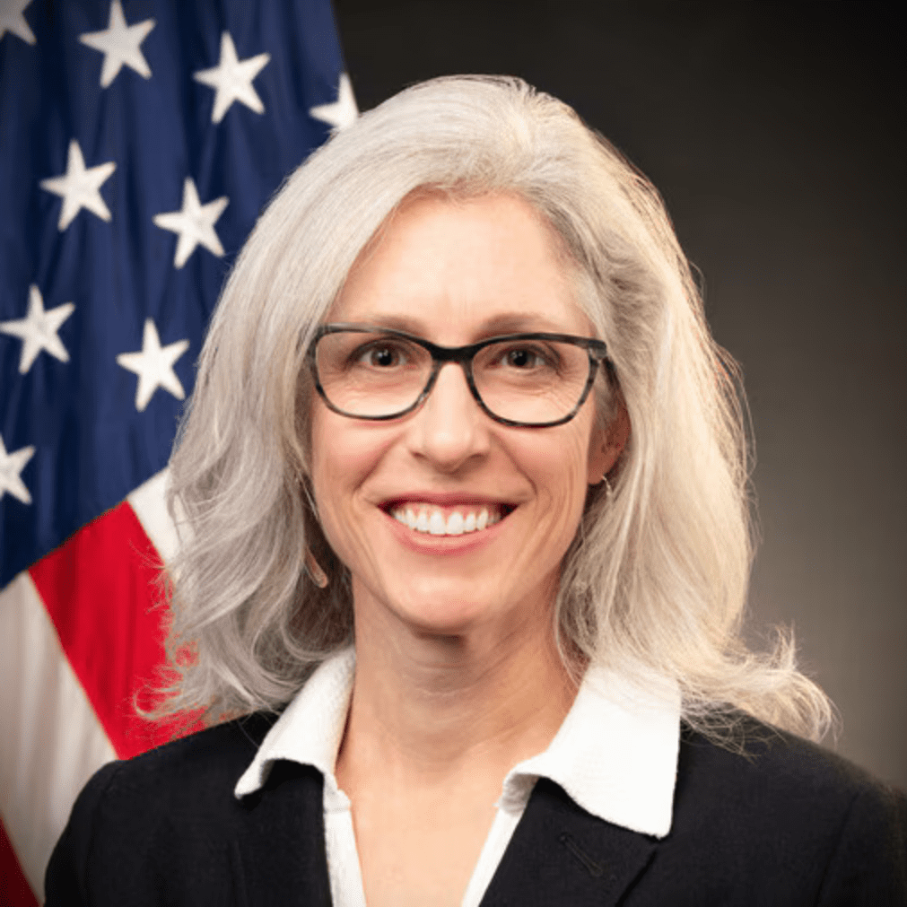 A headshot of Susan Monarez, with an American flag visible behind her