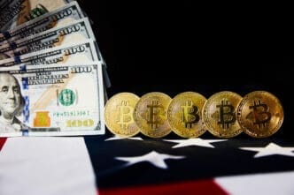 A fan of US hundred-dollar bills is on the left, a row of golden Bitcoin coins stands on the right, and the red, white, and blue of the American flag is in the foreground.