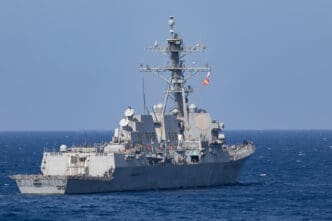 The USS Arleigh Burke (DDG 51) guided-missile destroyer sails on the open ocean.