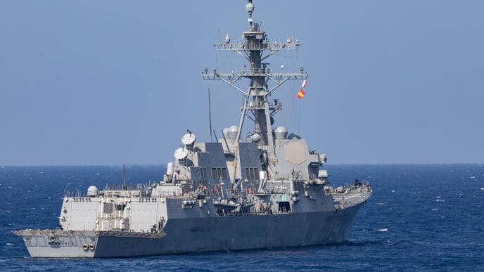 The USS Arleigh Burke (DDG 51) guided-missile destroyer sails on the open ocean.