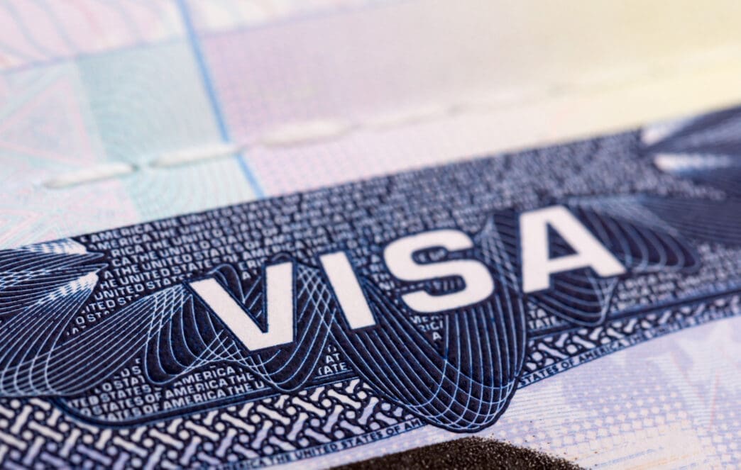 A close-up of a United States visa sticker with the word "VISA" prominently displayed