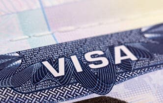 A close-up of a United States visa sticker with the word "VISA" prominently displayed