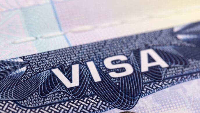 A close-up of a United States visa sticker with the word "VISA" prominently displayed