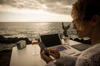 A professional woman works in a modern office with an ocean view.