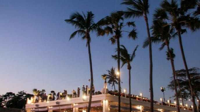 Blurred image of a beach party with many people enjoying themselves.